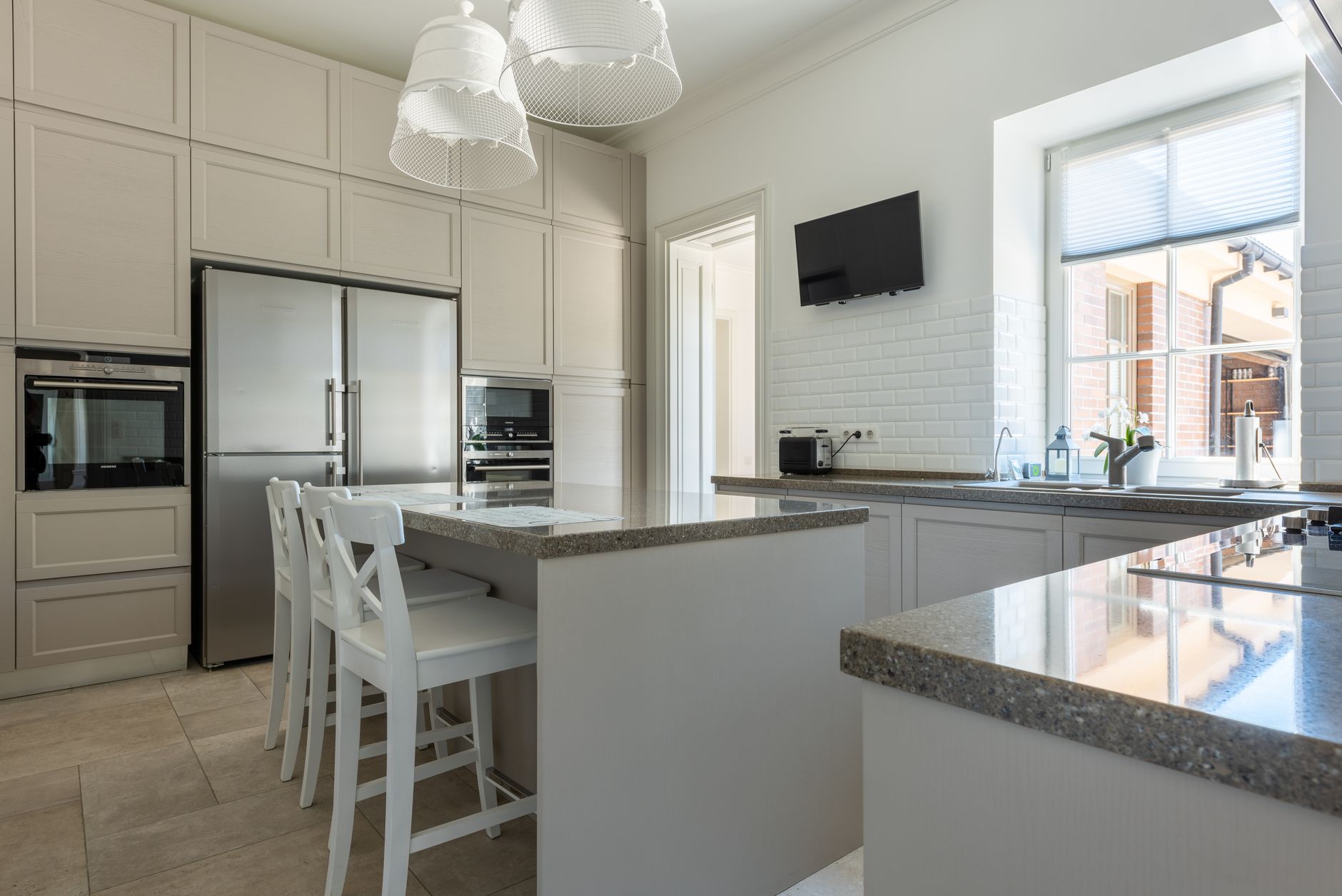 Spacious kitchen interior featuring granite countertops, stainless steel appliances, and a bright in Scottsdale, AZ